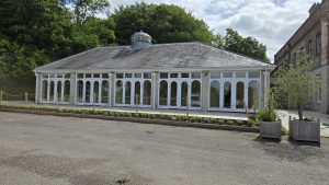 The Orangery at Rookesbury Park, a bright and elegant wedding venue in Hampshire with large arched windows and a countryside backdrop.