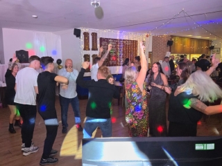 Guests dancing with colourful lights and lively atmosphere at a birthday celebration in Portsmouth, DJed by Heard The Beat.