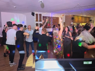 Guests dancing with colourful lights and lively atmosphere at a birthday celebration in Portsmouth, DJed by Heard The Beat.