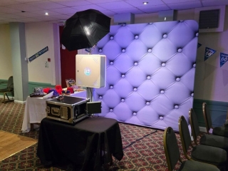 Professional photo booth setup with backdrop, props, and lighting at a Portsmouth event venue.