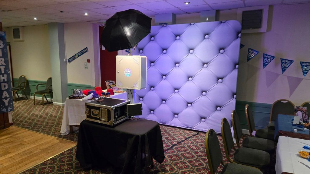 Professional photo booth setup with backdrop, props, and lighting at a Portsmouth event venue.
