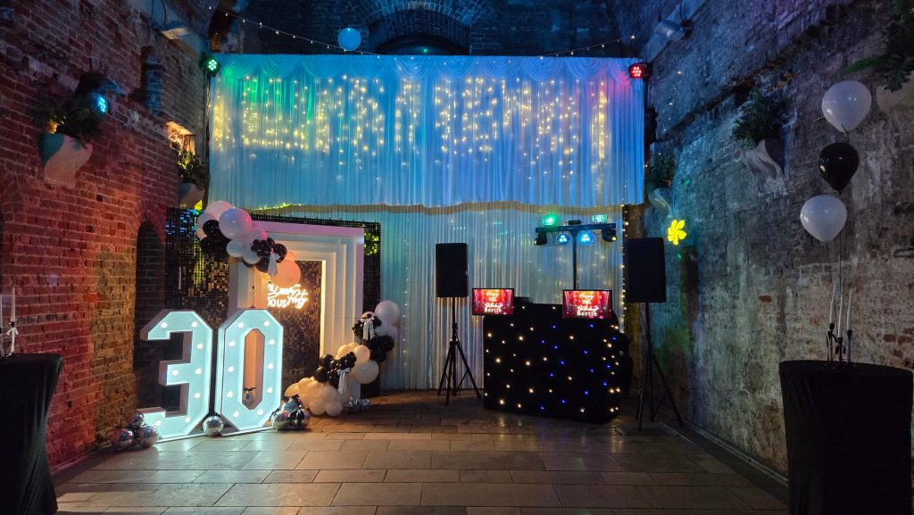 Professional DJ hire at Square Tower Portsmouth with Sassy Events décor including balloon arch and light-up 30 letters