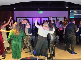 Guests enjoying a busy dance floor at a Christmas party with hands in the air, DJ entertainment by Heard The Beat in Portsmouth