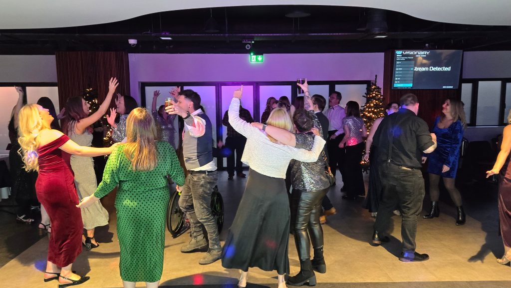 Guests enjoying a busy dance floor at a Christmas party with hands in the air, DJ entertainment by Heard The Beat in Portsmouth
