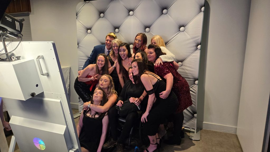 Guests enjoying a mirror photo booth at a corporate Christmas party in Fratton Park