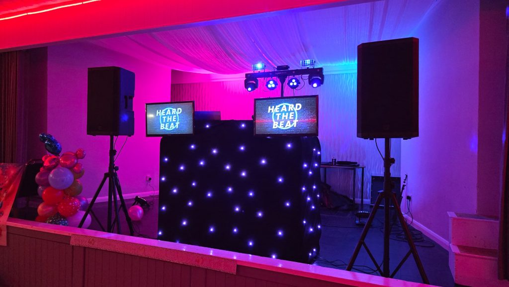 Heard The Beat DJ booth setup with lighting and dual display screens at a 40th birthday party in Lee-on-the-Solent Community Centre