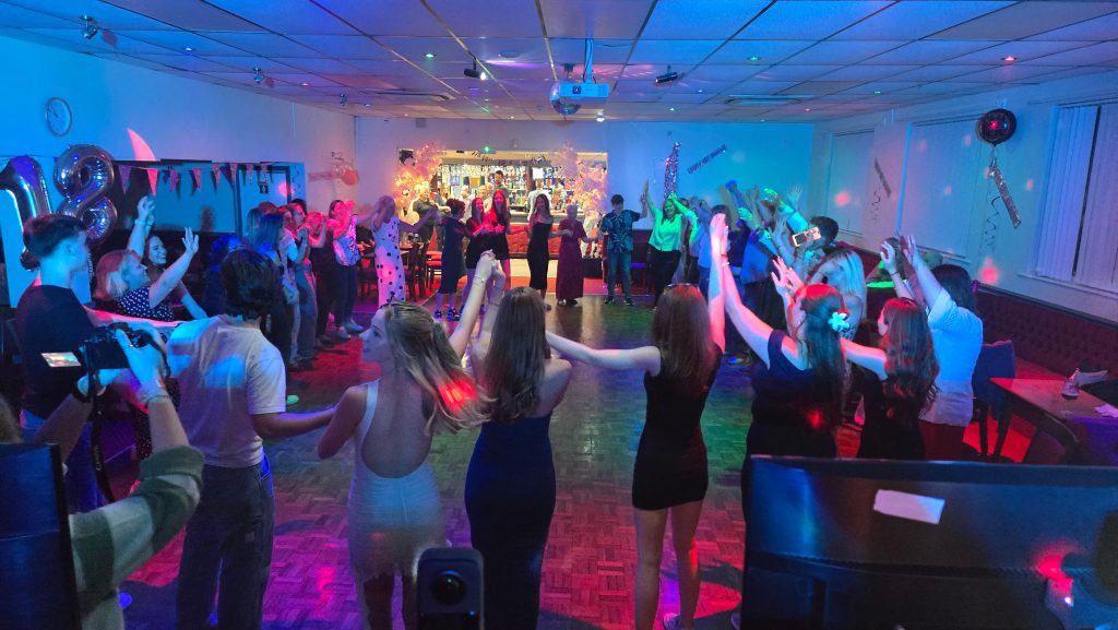 Guests dancing at a party at The Crofton Club in Stubbington with DJ entertainment and colourful dancefloor lighting