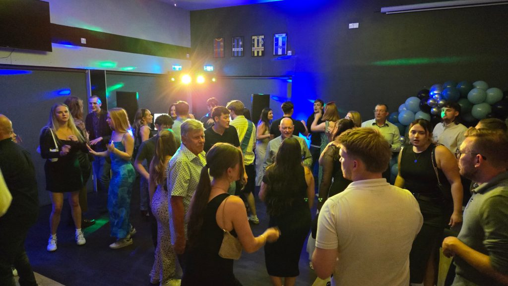 Birthday party guests dancing at Goals Portsmouth with professional DJ entertainment, colourful lighting and a high-energy atmosphere.