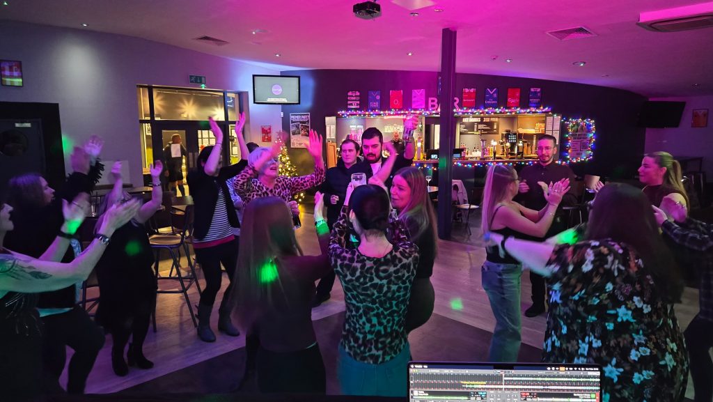 Evening celebration at Goals Portsmouth function room with DJ hire, modern lighting effects and guests dancing throughout the night.