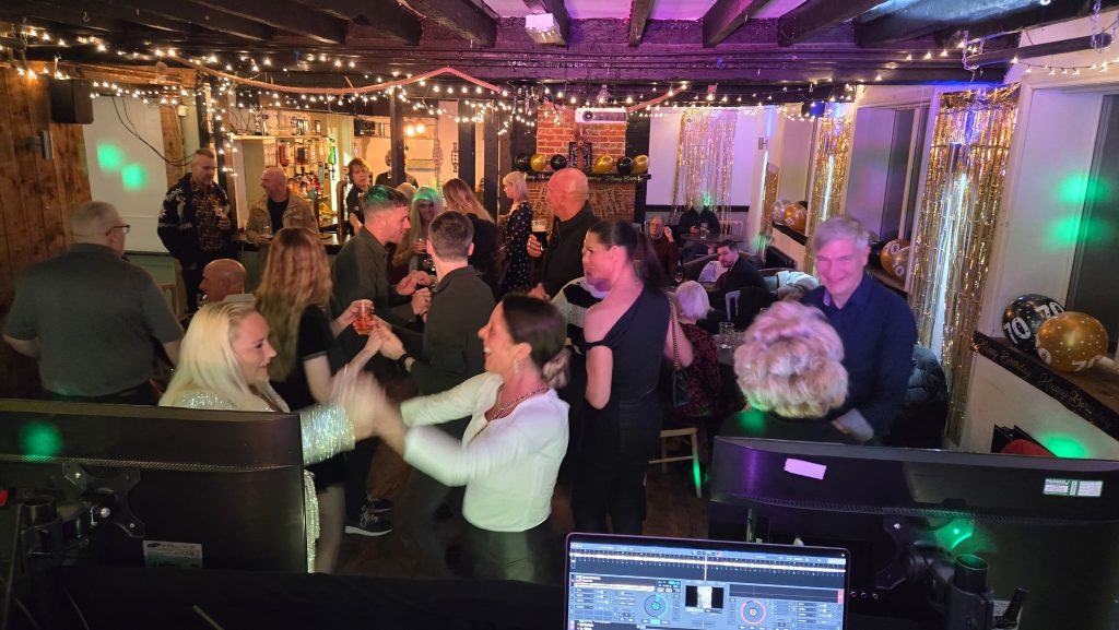 Guests enjoying a lively dancefloor at The Milton Arms Barn with DJ entertainment from Heard The Beat