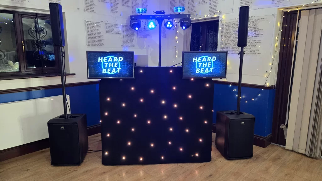 Professional DJ setup by Heard The Beat at Southsea Golf Club in Portsmouth, featuring an illuminated DJ booth, speakers and lighting ready for an evening event.