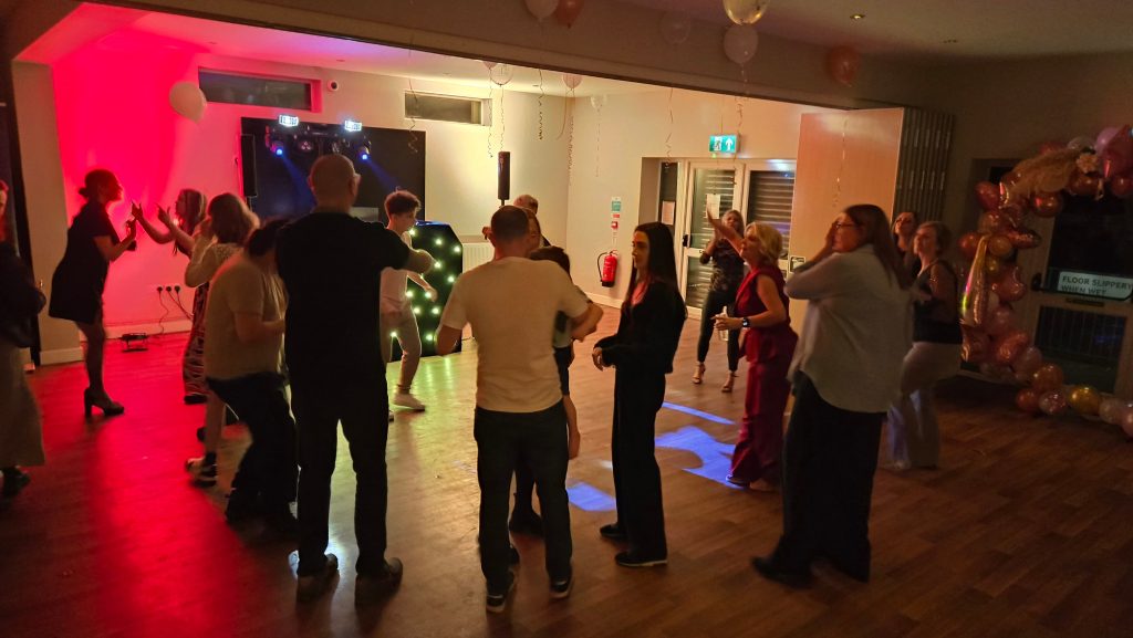 21st birthday party at Havant Rugby Club with DJ lighting and guests dancing on a busy dancefloor