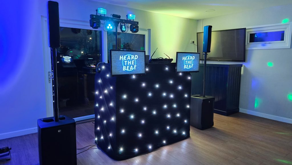 Professional DJ setup by Heard The Beat at Baffins Milton Rovers F.C. in Portsmouth with speakers, lighting and illuminated DJ booth ready for an evening event.