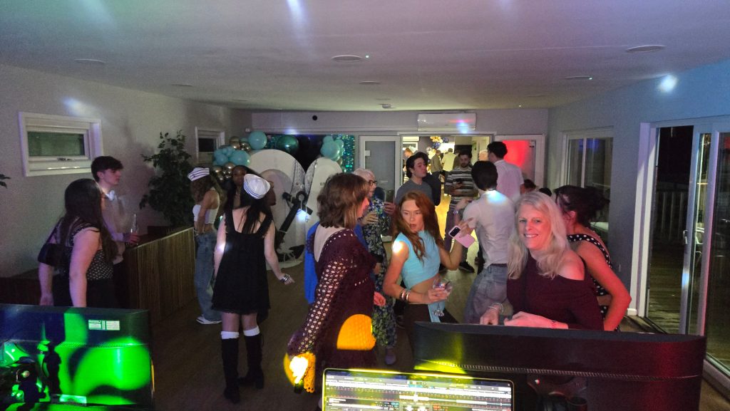 Guests enjoying a lively party on the dancefloor at Baffins Milton Rovers F.C. in Portsmouth with DJ lighting and music.