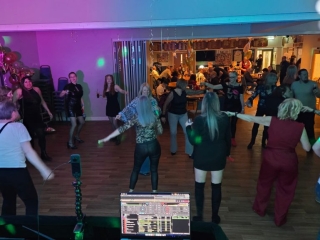 Guests dancing at a 21st birthday party at Havant Rugby Club with professional DJ setup and party lighting