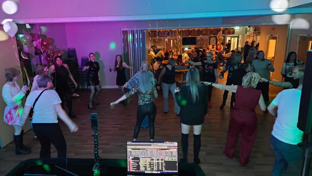 Guests dancing at a 21st birthday party at Havant Rugby Club with professional DJ setup and party lighting