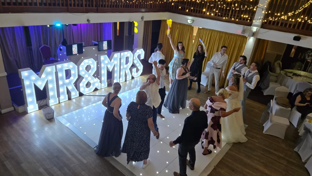 Guests dancing with Mr and Mrs light up letters at Royal Maritime Hotel Portsmouth wedding