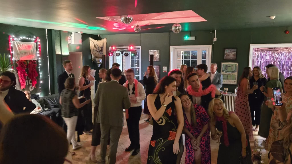 Busy wedding dancefloor at Southsea Tennis Club Portsmouth with DJ lighting