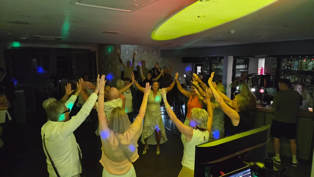 Guests celebrating on the dance floor during a surprise wedding and 60th birthday party at Skylark Golf & Country Club with Heard The Beat DJ entertainment.