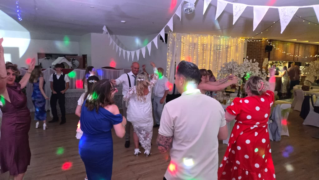 Wedding guests enjoying the dance floor during an evening wedding reception