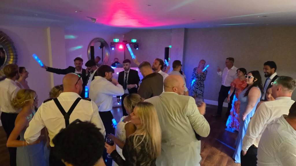Guests enjoying a packed dance floor during a wedding reception at The Wickham Estate with Heard The Beat Wedding DJ.