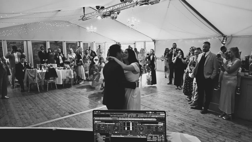 Bride and groom sharing their first dance at Southsea Castle with guests watching as Heard The Beat provides the wedding DJ entertainment.
