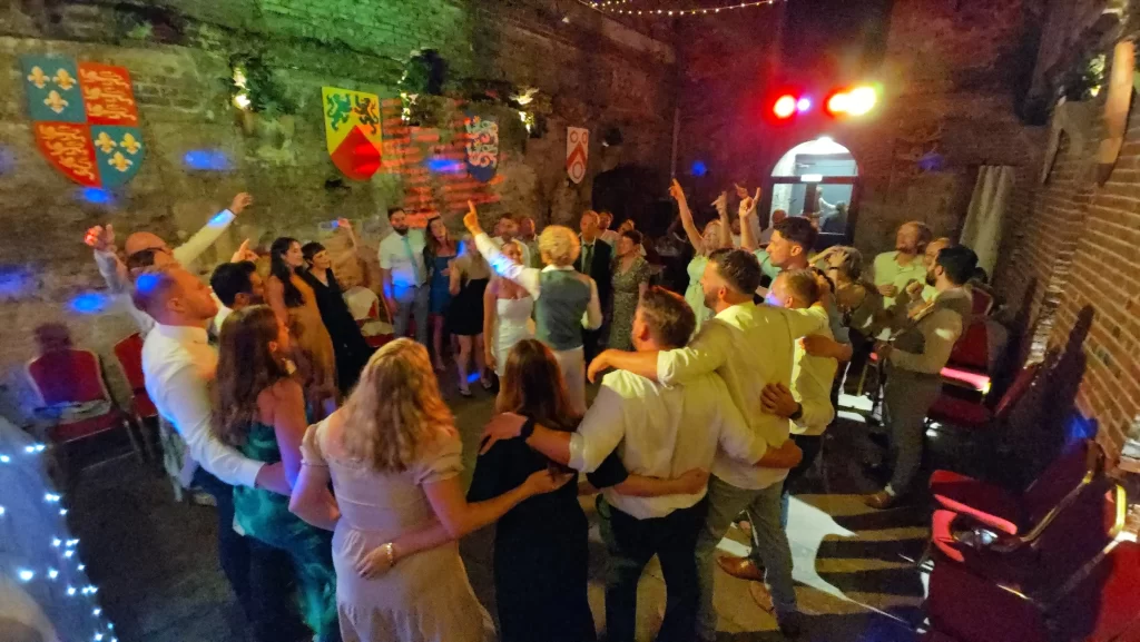 Wedding guests enjoying a packed dance floor during an evening reception at the Square Tower in Portsmouth, Hampshire.