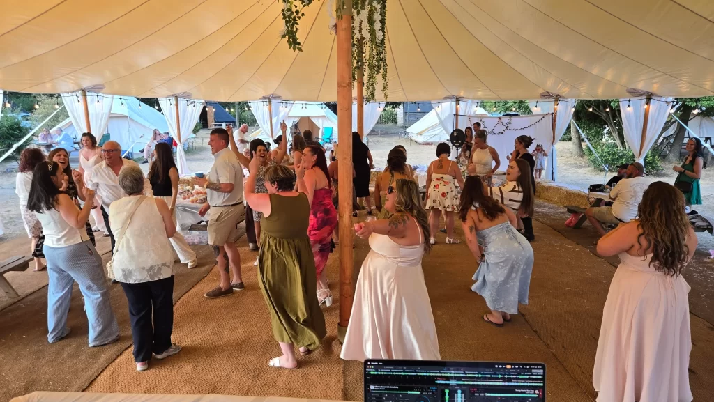 Wedding guests dancing inside the marquee at Bell Tent Glamping Southampton
